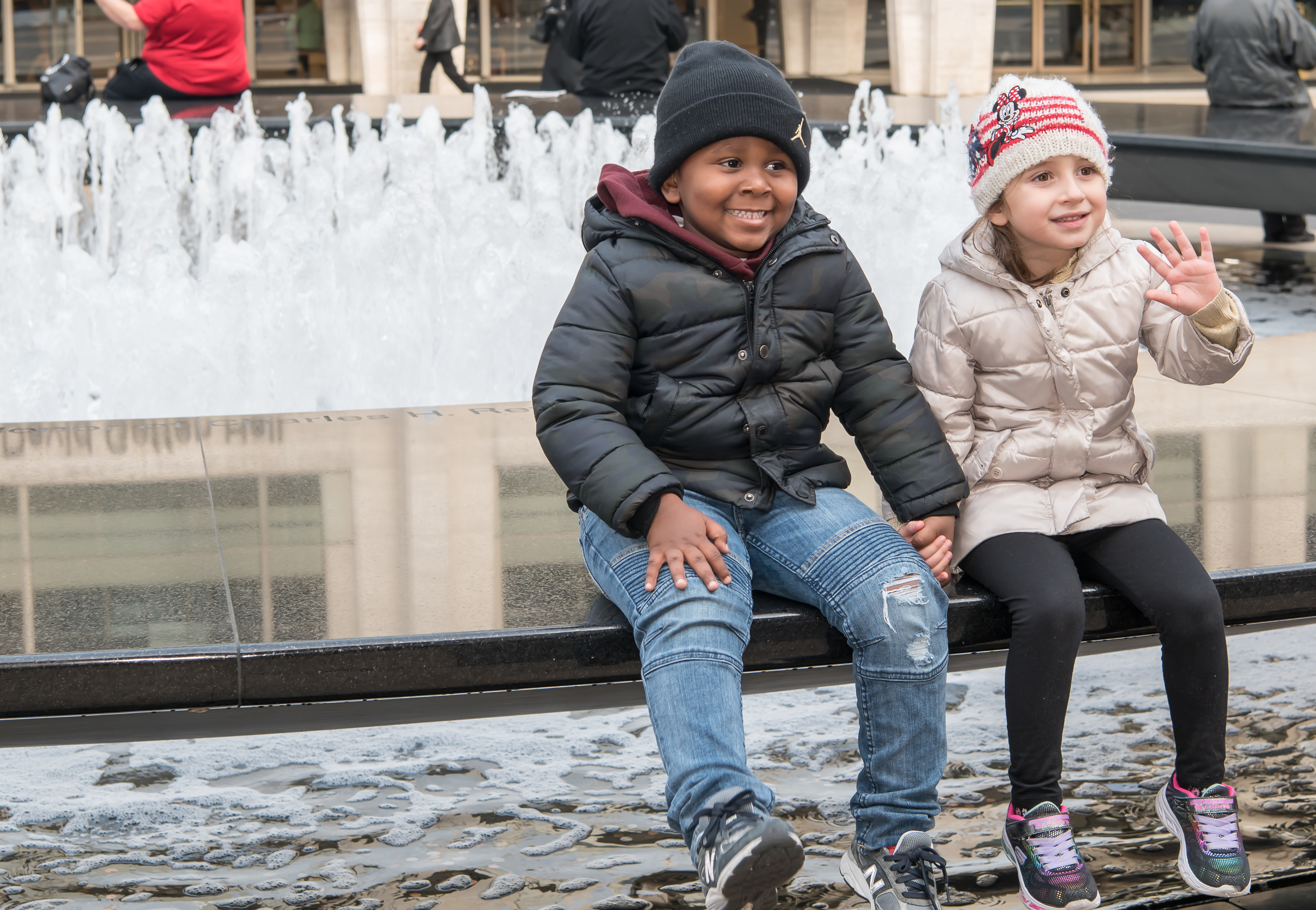 Children sitting by the fountain on Lincoln Center Plaza